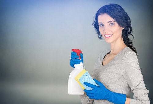Cleaner wearing PPE during carpet cleaning work